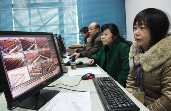 Test workers monitor exam venues at the University of South China in Hengyang, Hunan province, on Monday.