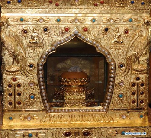 The Buddha's parietal-bone relic is placed inside the Ashoka pagoda at Qixia Temple in Nanjing, capital of east China's Jiangsu Province, April 25, 2012. A Grand Blessing Ceremony for worshipping Buddha's parietal-bone relic will be held in Hong Kong from April 25 to 30. The relic is being moved out of China's mainland for a public worship for the first time after it was unearthed in June 2010 in Nanjing. It will be send back to Nanjing on May 4. (Xinhua/Yang Lei)