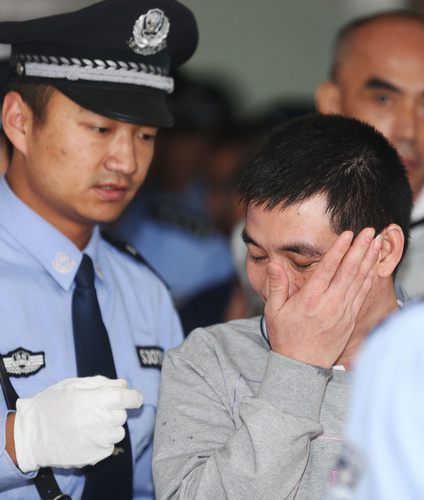 Naw Kham (right) at a Yunnan court on Sept 21. The Myanmar drug lord and his three accomplices will be executed on Friday afternoon in Kunming. [Wang Shen / Xinhua]