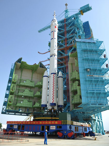 The Shenzhou X spacecraft and its rocket are moved into position at the Jiuquan Satellite Launch Center in Gansu province on Monday. Provided to China Daily