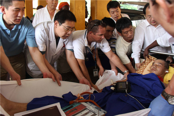 A worker is flown home to China for treatment after being injured in an explosion in the Republic of the Congo. The man was one of 31 Chinese workers injured the accident. Wang Minjie / Xinhua