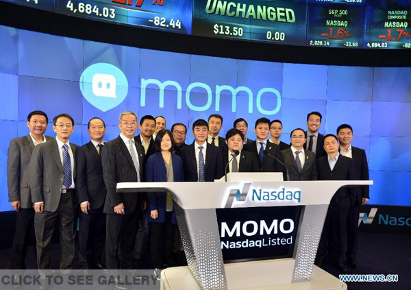Yan Tang (C, front), founder and chief executive officer of China's mobile social networking platform Momo Inc. attends the ceremony of ringing the opening bell at the NASDAQ in New York, the United States, on Dec 11, 2014. (Xinhua/Wang Lei) 