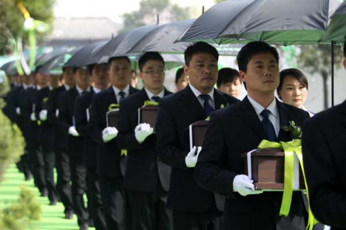 Employees of a funeral home hold cremation caskets at a funeral in Henan in March. (China Daily/Niu Yuan) Employees of a funeral home hold cremation caskets at a funeral in Henan in March. (China Daily/Niu Yuan)