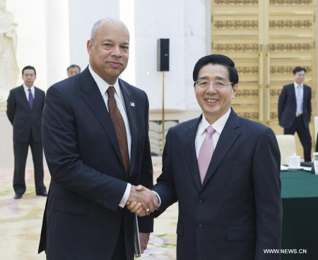 Chinese State Councilor and Public Security Minister Guo Shengkun (R) shakes hands with U.S. Secretary of Homeland Security Jeh Johnson during the first ministerial meeting between the Chinese Ministry of Public Security and the U.S. Homeland Security Department in Beijing, China, April 9, 2015. (Xinhua/Wang Ye)