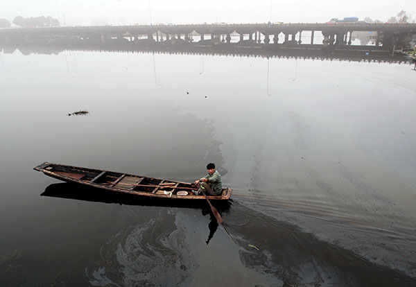 A man rows a boat through an oil slick on a lake in Shaoxing, Zhejiang province on March 16.Fuel leaking from ships severely contaminates the quality of the water in the lake. (Photo by Li Ruichang/China Daily) A man rows a boat through an oil slick on a lake in Shaoxing, Zhejiang province on March 16.Fuel leaking from ships severely contaminates the quality of the water in the lake. (Photo by Li Ruichang/China Daily)