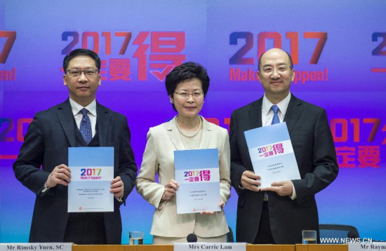 Carrie Lam Cheng Yuet-ngor (C), chief secretary for administration of Hong Kong Special Administrative Region (HKSAR), Secretary for Justice Rimsky Yuen (L), Secretary for Constitutional and Mainland Affairs Raymond Tam, shows the Consultation Report and Proposals on Method for Selecting the Chief Executive by Universal Suffrage in Hong Kong, south China, April 22, 2015.(Xinhua/He Jingjia) 