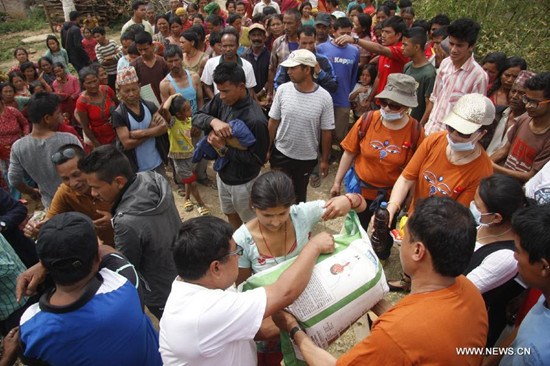 Locals gather to receive relief materials from China in quake-hit Lalitpur, Nepal, May 15, 2015. (Xinhua/Sunil Sharma)