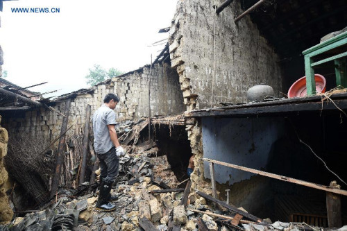 A villager clears the rubble of a house that is destroyed by heavy rain at Luojin Township of Yongfu County, south China's Guangxi Zhuang Autonomous Region, May 17, 2015. (Xinhua/Lu Boan) A villager clears the rubble of a house that is destroyed by heavy rain at Luojin Township of Yongfu County, south China's Guangxi Zhuang Autonomous Region, May 17, 2015. (Xinhua/Lu Boan)