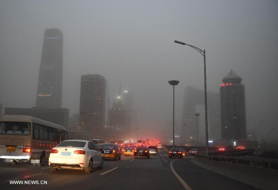 Buildings of Beijing Central Business District (CBD) loom up in the sandstorm in Beijing, China, on April 15, 2015.(Photo: Xinhua/Luo Xiaoguang) 
