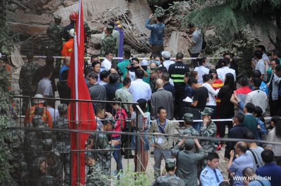 Rescuers search for survivors at a residential building collapse site in Guiyang, capital of southwest China's Guizhou Province, May 20, 2015. A nine-storey building collapsed in Guiyang on Wednesday. Rescuers have confirmed that there are people trapped inside, but casualties are not known yet. (Xinhua/Ou Dongqu) Rescuers search for survivors at a residential building collapse site in Guiyang, capital of southwest China's Guizhou Province, May 20, 2015. A nine-storey building collapsed in Guiyang on Wednesday. Rescuers have confirmed that there are people trapped inside, but casualties are not known yet. (Xinhua/Ou Dongqu)