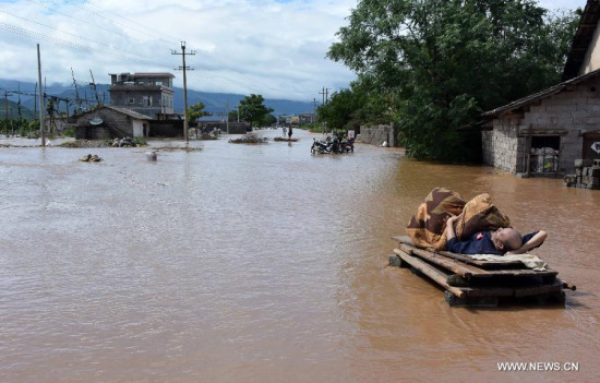 A man lying on wood boards waits for rescue in Jiahui Town of Gongcheng Yao Autonomous County, southwest China's Guangxi Zhuang Autonomous Region, May 20, 2015. (Xinhua/Zhou Hua) A man lying on wood boards waits for rescue in Jiahui Town of Gongcheng Yao Autonomous County, southwest China's Guangxi Zhuang Autonomous Region, May 20, 2015. (Xinhua/Zhou Hua)