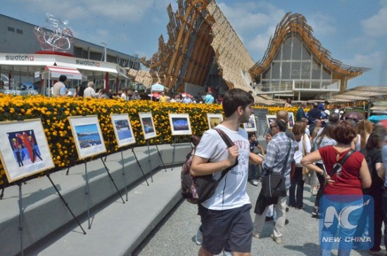 A photo exhibition on Beijing's bid for 2022 Winter Olympic Games kicks off in the landscape garden outside the China Pavilion of Expo Milano 2015 to show photos of winter venues and achieved results by Chinese athletes, in Milan, Italy, on May 30, 2015. (Photo/Xinhua)