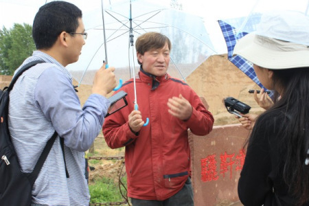 Sun Jianjun (C) receives an interview. 