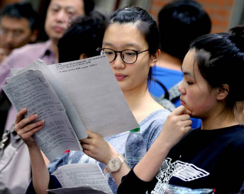 Students make their final preparations before entering the classroom for the national college entrance exam in Shanghai on Sunday. (Liu Ying/Xinhua)