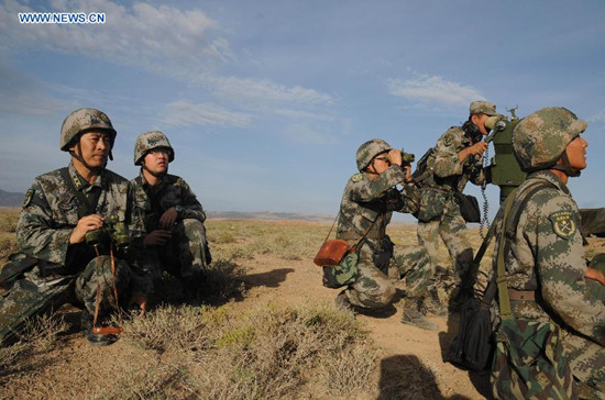 Soldiers take part in a drill in northwest China's Gansu Province, July 1, 2015. The People's Liberation Army (PLA) began a series of air-ground combat drills in Gansu on Wednesday. According to the PLA, seven live ammunition drills, dubbed Gunpower 2015 Shandan will be held in the Hexi Corridor, a green area between two large deserts, before middle September. (Photo: Xinhua/Li Yun) Soldiers take part in a drill in northwest China's Gansu Province, July 1, 2015. The People's Liberation Army (PLA) began a series of air-ground combat drills in Gansu on Wednesday. According to the PLA, seven live ammunition drills, dubbed Gunpower 2015 Shandan will be held in the Hexi Corridor, a green area between two large deserts, before middle September. (Photo: Xinhua/Li Yun)