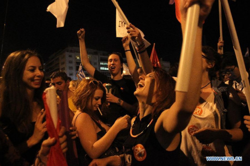 Supporters of the No vote react after the first result of the referendum at Syntagma square in Athens, Sunday, July 5, 2015. (Photo: Xinhua/Marios Lolos) Supporters of the No vote react after the first result of the referendum at Syntagma square in Athens, Sunday, July 5, 2015. (Photo: Xinhua/Marios Lolos)