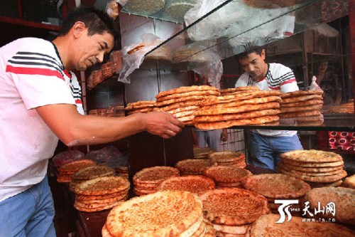 Ablikim tursun in his naan shop. (Photo/ts.cn) Ablikim tursun in his naan shop. (Photo/ts.cn)