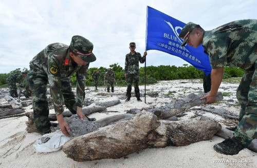 Blue Ribbon volunteers from Sansha Public Security Frontier Detachment clean up a seashore on the Yongxing island of Sansha City, south China's Hainan Province, July 17, 2015. Volunteers of Blue Ribbon Service Team cleaned up the seashores on July 17, a move to greet the third anniversary of the establishment of Sansha city. (Photo: Xinhua/Zhao Yingquan) Blue Ribbon volunteers from Sansha Public Security Frontier Detachment clean up a seashore on the Yongxing island of Sansha City, south China's Hainan Province, July 17, 2015. Volunteers of Blue Ribbon Service Team cleaned up the seashores on July 17, a move to greet the third anniversary of the establishment of Sansha city. (Photo: Xinhua/Zhao Yingquan)