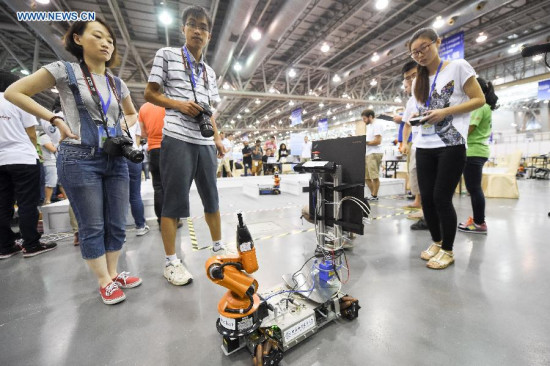 A student from the University of Science and Technology of China (USTC) controls Kuka Worker during the Robocup 2014 competition in Hefei, capital of east China's Anhui Province, July 20, 2015. Four teams of the USTC participated in the four-day competition that kicked off here on July 19. (Photo: Xinhua/Zhang Duan) A student from the University of Science and Technology of China (USTC) controls Kuka Worker during the Robocup 2014 competition in Hefei, capital of east China's Anhui Province, July 20, 2015. Four teams of the USTC participated in the four-day competition that kicked off here on July 19. (Photo: Xinhua/Zhang Duan)