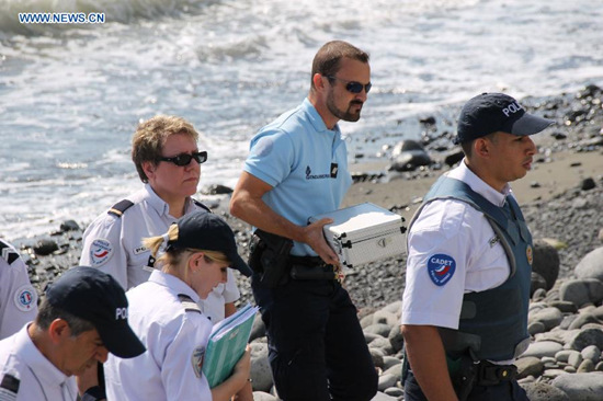 Police officers leave the beach with a container holding metallic debris found on it in Saint-Denis, the Reunion Island, Aug. 2, 2015. (Photo: Xinhua/Romain Latournerie) Police officers leave the beach with a container holding metallic debris found on it in Saint-Denis, the Reunion Island, Aug. 2, 2015. (Photo: Xinhua/Romain Latournerie)