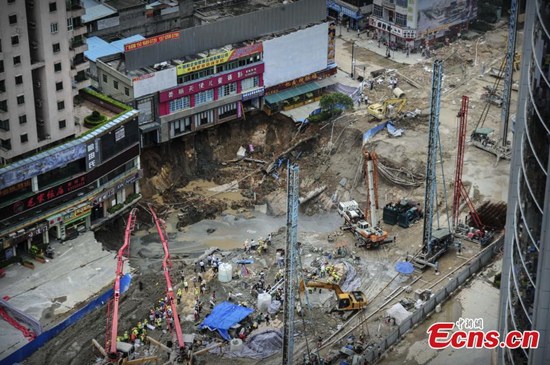 Workers fill a cave-in with cement at a subway construction site in Dongguan city, South China’s Guangdong province, Aug 13, 2015. One worker died after a 300-square-meter area collapsed at the site. A car was also swallowed into the hole during the collapse on Wednesday. The accident also caused water and gas pipelines to burst. (Photo: China News Service/Chen Jimin) Workers fill a cave-in with cement at a subway construction site in Dongguan city, South China’s Guangdong province, Aug 13, 2015. One worker died after a 300-square-meter area collapsed at the site. A car was also swallowed into the hole during the collapse on Wednesday. The accident also caused water and gas pipelines to burst. (Photo: China News Service/Chen Jimin)