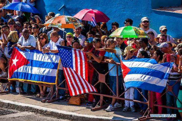 People watch flag-raising ceremony at the U.S. embassy in Havana, Cuba, Aug. 14, 2015. U.S. Secretary of State John Kerry chaired here on Friday the formal ceremony of raising the American flag in the recently reopened U.S. embassy in Cuba, after 54 years of animosity between the two neighbors. (Photo: Xinhua/Liu Bin) People watch flag-raising ceremony at the U.S. embassy in Havana, Cuba, Aug. 14, 2015. U.S. Secretary of State John Kerry chaired here on Friday the formal ceremony of raising the American flag in the recently reopened U.S. embassy in Cuba, after 54 years of animosity between the two neighbors. (Photo: Xinhua/Liu Bin)