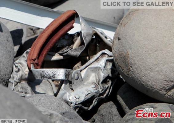 Metallic debris is found on a beach in Saint-Denis on the French Reunion Island in the Indian Ocean, Aug 2, 2015. Locals on La Reunion island have been combing the shores since a Boeing 777 wing part was found on last Wednesday, sparking fevered speculation that it may be the first tangible evidence that the Malaysia Airlines plane crashed into the Indian Ocean. Police collected the mangled piece of metal inscribed with two Chinese characters 