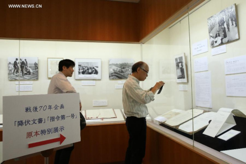 Visitors look at the original Instrument of Surrender of Japan's surrender to the Allied Forces in World War II, at an exhibition in Tokyo, Japan, Sept. 1, 2015. (Photo: Xinhua/Liu Tian) Visitors look at the original Instrument of Surrender of Japan's surrender to the Allied Forces in World War II, at an exhibition in Tokyo, Japan, Sept. 1, 2015. (Photo: Xinhua/Liu Tian)