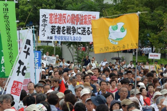 rotesters attend a rally against the controversial security bills in Osaka, Japan, Aug. 30, 2015. (Xinhua file photo/Yan Lei) rotesters attend a rally against the controversial security bills in Osaka, Japan, Aug. 30, 2015. (Xinhua file photo/Yan Lei)