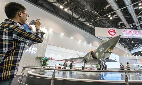 A visitor takes a picture of a model of a fourth-generation fighter FC-31 being showcased at Aviation Expo China 2015, in Beijing on Wednesday. (Photo: Li Hao/GT) A visitor takes a picture of a model of a fourth-generation fighter FC-31 being showcased at Aviation Expo China 2015, in Beijing on Wednesday. (Photo: Li Hao/GT)