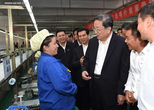 Yu Zhengsheng, chairman of the National Committee of the Chinese People's Political Consultative Conference (CPPCC), talks with workers at production lines of electronic products in the economic development zone in Kashgar, northwest China's Xinjiang Uygur Autonomous Region, Sept. 26, 2015. (Photo: Xinhua/Rao Aimin) Yu Zhengsheng, chairman of the National Committee of the Chinese People's Political Consultative Conference (CPPCC), talks with workers at production lines of electronic products in the economic development zone in Kashgar, northwest China's Xinjiang Uygur Autonomous Region, Sept. 26, 2015. (Photo: Xinhua/Rao Aimin)