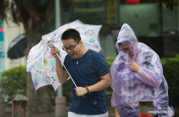 People walk in rainstorm in Xiamen, a coastal city in southeast China's Fujian Province, Sept. 29, 2015. Typhoon Dujuan, the 21st typhoon this year, made landfall in the province on Tuesday morning. (Photo: Xinhua/Jiang Kehong) People walk in rainstorm in Xiamen, a coastal city in southeast China's Fujian Province, Sept. 29, 2015. Typhoon Dujuan, the 21st typhoon this year, made landfall in the province on Tuesday morning. (Photo: Xinhua/Jiang Kehong)