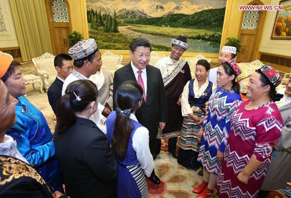 Chinese President Xi Jinping (C) meets with 13 outstanding grass-roots ethnic solidarity representatives at the Great Hall of the People in Beijing, capital of China, Sept. 30, 2015. On the 66th anniversary of the founding of the People's Republic of China, President Xi Jinping invited the 13 outstanding grass-roots ethnic solidarity representatives, who are from the five autonomous regions of Inner Mongolia, Guangxi, Tibet, Ningxia and Xinjiang, to Beijing to attend the national day celebrations. (Xinhua/Yao Dawei) Chinese President Xi Jinping (C) meets with 13 outstanding grass-roots ethnic solidarity representatives at the Great Hall of the People in Beijing, capital of China, Sept. 30, 2015. On the 66th anniversary of the founding of the People's Republic of China, President Xi Jinping invited the 13 outstanding grass-roots ethnic solidarity representatives, who are from the five autonomous regions of Inner Mongolia, Guangxi, Tibet, Ningxia and Xinjiang, to Beijing to attend the national day celebrations. (Xinhua/Yao Dawei)