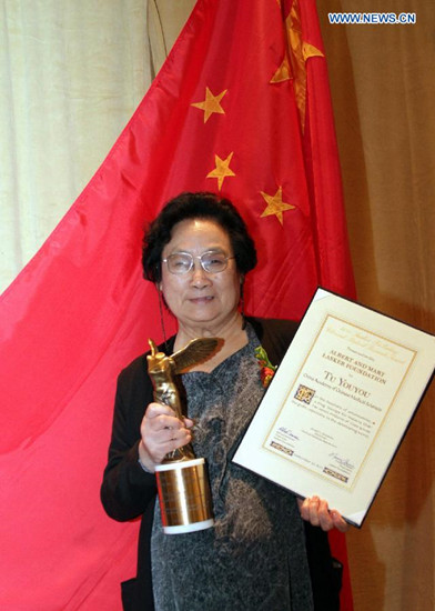 File photo taken on Sept. 23, 2011 shows Chinese Pharmacologist Tu Youyou posing with her trophy after winning the Lasker Award, a prestigious U.S. award, in New York, the United States. China's Tu Youyou, Irish-born William Campbell, and Japan's Satoshi Omura jointly won the 2015 Nobel Prize for Physiology or Medicine, the Nobel Assembly at Sweden's Karolinska Institute announced on Monday.(Xinhua/Wang Chengyun) File photo taken on Sept. 23, 2011 shows Chinese Pharmacologist Tu Youyou posing with her trophy after winning the Lasker Award, a prestigious U.S. award, in New York, the United States. China's Tu Youyou, Irish-born William Campbell, and Japan's Satoshi Omura jointly won the 2015 Nobel Prize for Physiology or Medicine, the Nobel Assembly at Sweden's Karolinska Institute announced on Monday.(Xinhua/Wang Chengyun)