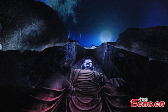 Statues and wall paintings are showed on a giant spherical screen at the digital center of the Mogao Grottoes in Dunhuang city, Northwest Chinas Gansu province. (Photo: China News Service/Yang Yanmin)