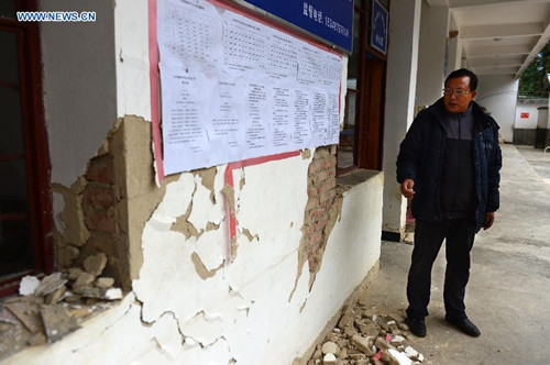 Wang Shaojun, a headmaster of a primary school, checks the campus after an earthquake hit the small town of Datianba in southwest China's Yunnan Province, Oct. 31, 2015. According to the provincial civil affairs department, 856 people were forced to evacuate, while 168 houses collapsed and over 12,000 were damaged after the 5.1-magnitude earthquake. (Xinhua/Hu Chao) Wang Shaojun, a headmaster of a primary school, checks the campus after an earthquake hit the small town of Datianba in southwest China's Yunnan Province, Oct. 31, 2015. According to the provincial civil affairs department, 856 people were forced to evacuate, while 168 houses collapsed and over 12,000 were damaged after the 5.1-magnitude earthquake. (Xinhua/Hu Chao)