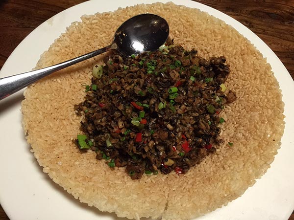 A Hunan taco with stir-fried pork, onion, garlic and herbs piled on a cracker. (Photo:China Daily/Mike Peters) A Hunan taco with stir-fried pork, onion, garlic and herbs piled on a cracker. (Photo:China Daily/Mike Peters)