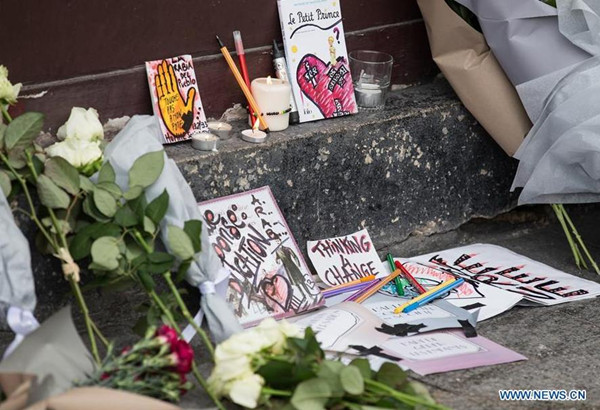 Flowers and cards are placed in front of the Le Petit Cambodge Restaurant where an attack happend the other day in Paris, France, Nov. 14, 2015. French President Francois Hollande announced a three-days national mourning on Saturday. (Photo: Xinhua/Xu Jinquan) Flowers and cards are placed in front of the Le Petit Cambodge Restaurant where an attack happend the other day in Paris, France, Nov. 14, 2015. French President Francois Hollande announced a three-days national mourning on Saturday. (Photo: Xinhua/Xu Jinquan)