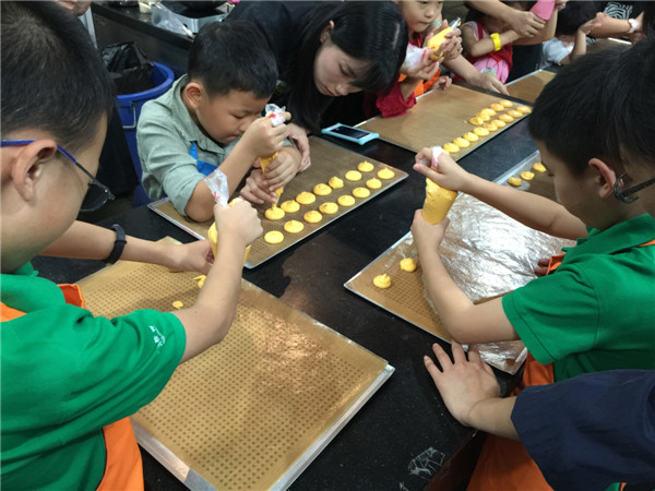 Primary-grade students from a Beijing language academy at Gateaux& Cadeaux for a lesson in making macaroons. (Photo by Mike Peters/China Daily) Primary-grade students from a Beijing language academy at Gateaux& Cadeaux for a lesson in making macaroons. (Photo by Mike Peters/China Daily)