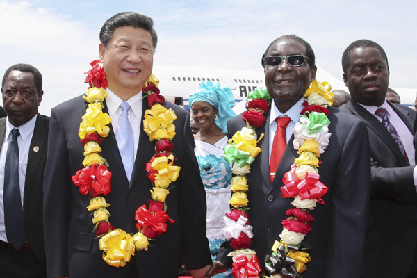 President Xi Jinping is welcomed by Zimbabwe's President Robert Mugabe upon his arrival in Harare on Tuesday. Xi called close ties with Zimbabwe a cornerstone of China's foreign policy.(Photo by Lan Hongguang/Xinhua) President Xi Jinping is welcomed by Zimbabwe's President Robert Mugabe upon his arrival in Harare on Tuesday. Xi called close ties with Zimbabwe a cornerstone of China's foreign policy.(Photo by Lan Hongguang/Xinhua)