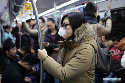 A passenger wears a mask as she takes a subway in Beijing, capital of China, Dec. 8, 2015. Beijing has issued its first red alert for air pollution under a four-tier emergency response system created in October 2013. (Photo: Xinhua/Jin Liwang) A passenger wears a mask as she takes a subway in Beijing, capital of China, Dec. 8, 2015. Beijing has issued its first red alert for air pollution under a four-tier emergency response system created in October 2013. (Photo: Xinhua/Jin Liwang)