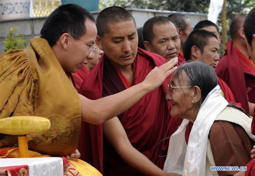 The file photo taken on Aug. 6, 2012 shows the 11th Panchen Lama, Bainqen Erdini Qoigyijabu, offering head-touching blessings to a Buddhist believer in Xigaze, southwest China's Tibet Autonomous Region. (Xinhua/Chogo) The file photo taken on Aug. 6, 2012 shows the 11th Panchen Lama, Bainqen Erdini Qoigyijabu, offering head-touching blessings to a Buddhist believer in Xigaze, southwest China's Tibet Autonomous Region. (Xinhua/Chogo)