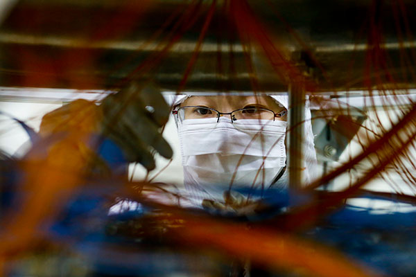 A scientist checks equipment designed for dark matter research at Jinping Underground Laboratory. SHEN BOHAN/XINHUA A scientist checks equipment designed for dark matter research at Jinping Underground Laboratory. SHEN BOHAN/XINHUA
