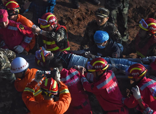 A survivor is found at the site of landslide at an industrial park in Shenzhen, south China's Guangdong Province, Dec. 23, 2015. One man was pulled out alive early Wednesday morning more than 60 hours after a landslide in Shenzhen. (Xinhua/Jin Liangkuai) A survivor is found at the site of landslide at an industrial park in Shenzhen, south China's Guangdong Province, Dec. 23, 2015. One man was pulled out alive early Wednesday morning more than 60 hours after a landslide in Shenzhen. (Xinhua/Jin Liangkuai)
