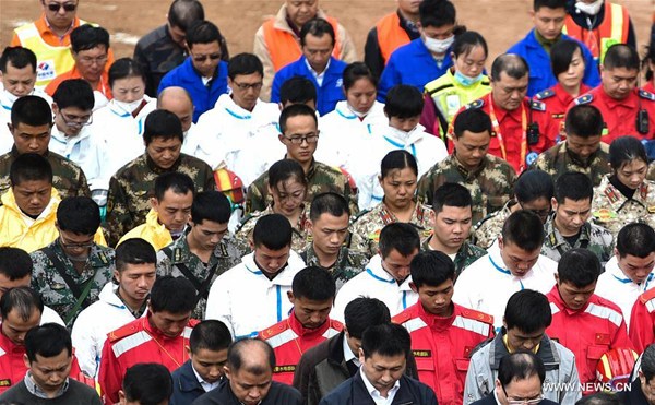Rescuers mourn for the victims at the landslide site at an industrial park in Shenzhen, south China's Guangdong Province, Dec. 26, 2015. So far only one man has been pulled from the debris. The death toll is confirmed at seven, with 75 still unaccounted for. Rescue work continues although their chance of survival dims with time. (Xinhua/Mao Siqian) Rescuers mourn for the victims at the landslide site at an industrial park in Shenzhen, south China's Guangdong Province, Dec. 26, 2015. So far only one man has been pulled from the debris. The death toll is confirmed at seven, with 75 still unaccounted for. Rescue work continues although their chance of survival dims with time. (Xinhua/Mao Siqian)
