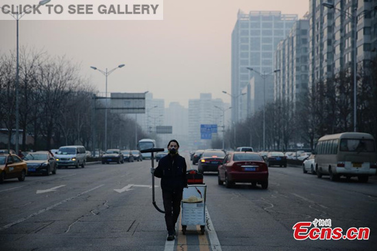 "But brother" wearing mask collects dust on a street in Wangjing District of Beijing. (Photo/CFP)