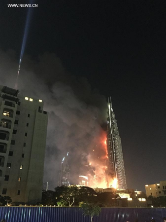Photo taken by a mobile device shows Address Downtown Dubai hotel on fire in Dubai, the United Arab Emirates, on Dec. 31, 2015. Fire broke out on Thursday in a luxurious hotel in Dubai where people were gathering nearby to watch the New Year's fireworks show. (Xinhua/Liu Yang) Photo taken by a mobile device shows Address Downtown Dubai hotel on fire in Dubai, the United Arab Emirates, on Dec. 31, 2015. Fire broke out on Thursday in a luxurious hotel in Dubai where people were gathering nearby to watch the New Year's fireworks show. (Xinhua/Liu Yang)