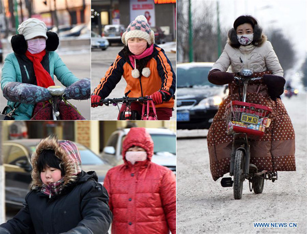 Residents are seens wearing heavy in Binzhou, east China's Shandong Province on Jan. 23, 2016. Lowest temperature dropped to minus 19 degrees Celsius here on Saturday. (Xinhua/Zhou Ke) Residents are seens wearing heavy in Binzhou, east China's Shandong Province on Jan. 23, 2016. Lowest temperature dropped to minus 19 degrees Celsius here on Saturday. (Xinhua/Zhou Ke)