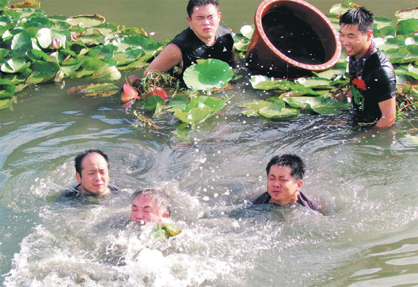 Yu Dan (middle) and student researchers attempt to plant aquatic seedlings in the bed of Liangzi Lake. (Photo provided to China Daily) Yu Dan (middle) and student researchers attempt to plant aquatic seedlings in the bed of Liangzi Lake. (Photo provided to China Daily)