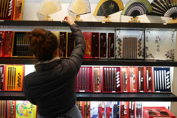 A salesperson at the Yunhong Chopsticks store in Manhattan's Chinatown. The shop's most popular chopsticks with tourists are those that feature zodiac signs. AMY HE / CHINA DAILY A salesperson at the Yunhong Chopsticks store in Manhattan's Chinatown. The shop's most popular chopsticks with tourists are those that feature zodiac signs. AMY HE / CHINA DAILY